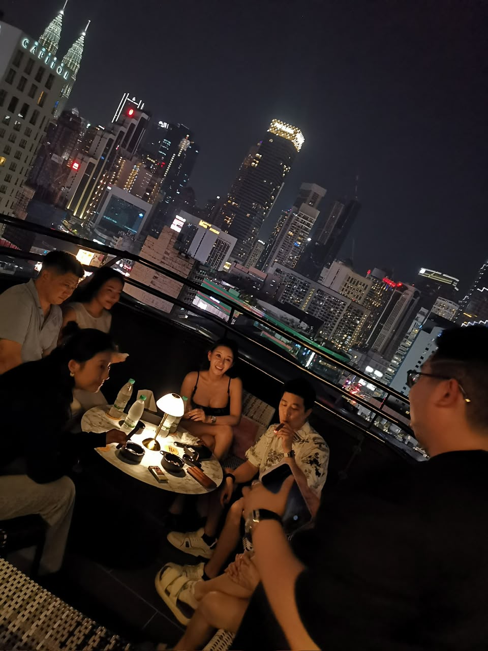 Kuala Lumpur after dark from the terrace — Petronas Towers on the skyline.